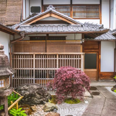 An entrance to a japanese traditional hotel. Sliding doors at a ryokan in Japan. A yard of a traditional japanese house